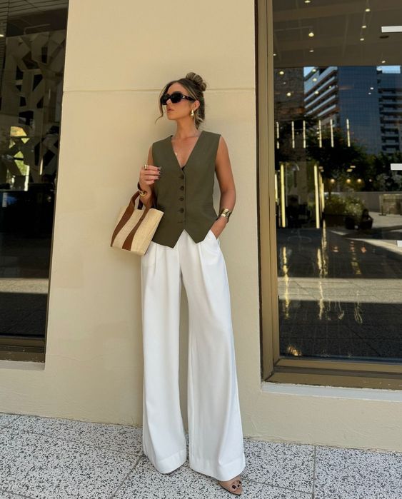 Olive green sleeveless vest with white wide-leg trousers